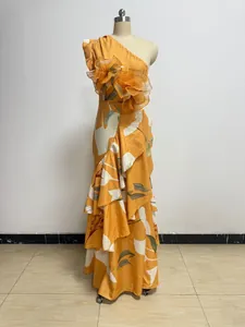 Detailed view of a yellow one-shoulder floral dress with ruffled 3D flower embellishments.