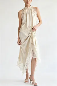 Detail shot of cream silk-like sleeveless top and lace slit skirt set on a model.