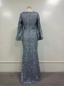 Detailed back view of a silver sequined evening gown featuring flared bell sleeves