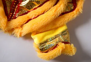 Detailed macro view of yellow faux fur and gold sequins on pet lion dance costume detail