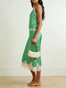 Elegant emerald green satin two-piece loungewear set with delicate cream lace trim details