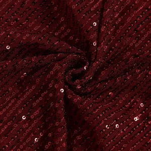 Macro view of high-quality sparkling burgundy sequin fabric on mesh base for evening wear