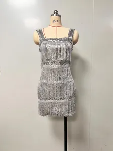Detailed view of a shimmering silver sequined party dress with tiered fringe on a mannequin