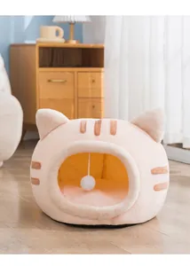Close-up detail of the cozy pink cat head shaped plush pet bed with a hanging ball