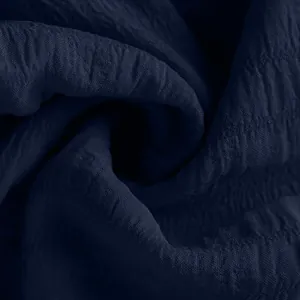 Close-up detail of textured navy blue fabric for summer drawstring sports shorts.