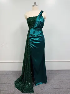 Elegant dark green one-shoulder evening gown with sequins and satin draping details