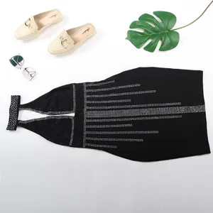 Detail of sexy black halter bodycon dress with sparkling silver rhinestone stripes