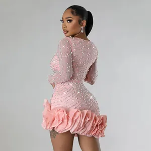 Back detail of pink long sleeve mini dress featuring dense pearl and rhinestone work