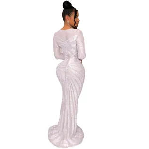 Back view of white long-sleeved floor-length dress with radiant rhinestone patterns