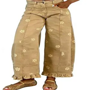 Vintage Y2K khaki wide leg jeans featuring white floral daisy print and ruffle hem design.