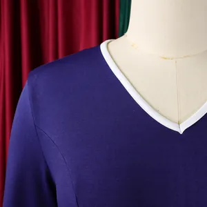 Close-up detail of the white V-neckline and textured fabric on a blue professional dress