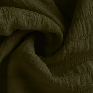 Macro detail of textured dark olive green lightweight fabric for summer sports shorts.