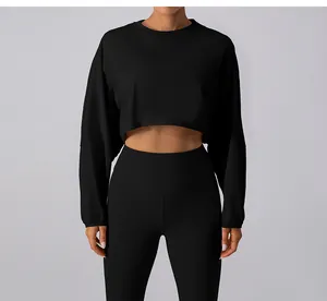 Front view of a minimalist black long-sleeve crop top sweatshirt designed for yoga and fitness