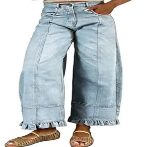 Detail view of light blue Y2K vintage washed denim jeans with unique ruffle hem and patchwork
