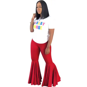 Primer plano de pantalones acampanados rojos con volantes y camiseta blanca
