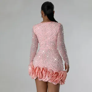 Back detail of pink long sleeve mini dress with rhinestones and pearl flower hem