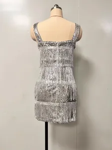 Back view of a silver sequin dress with fringe details on a mannequin for party wear.
