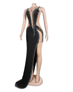 Detailed side view of a sexy black evening gown featuring rhinestones and mesh panels