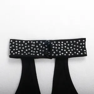 Close-up view of a sexy black halter neck dress featuring sparkling rhinestones and buttons.