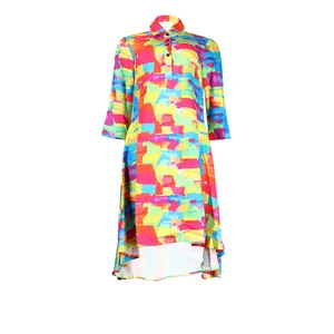 Close-up detail of a vibrant colorful abstract print shirt dress with high-low hemline