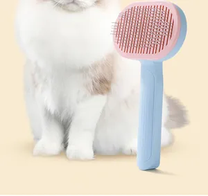 Detail view of pink and blue pet grooming brush with stainless steel needles for cats and dogs.