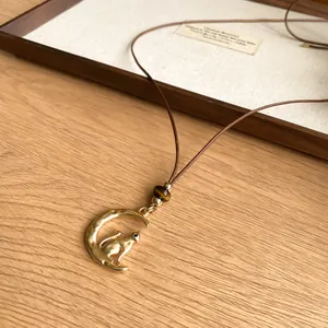 Korean style moon and cat pendant necklace with brown cord and bead detail