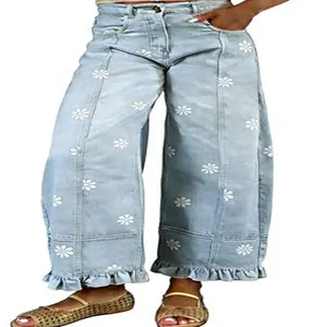 Close-up detail of light blue floral print wide-leg denim jeans with unique ruffled hems
