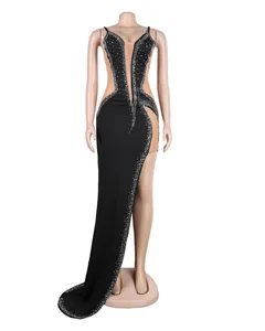 Detailed view of a sexy black rhinestone evening dress with high slit and mesh panels.