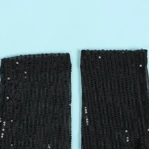 Close-up shot of black mesh fabric featuring shimmering vertical sequin embroidery