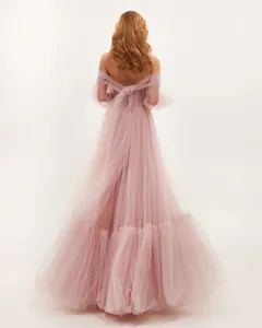 Elegant back view of off-the-shoulder pink tulle evening gown with large bow detail
