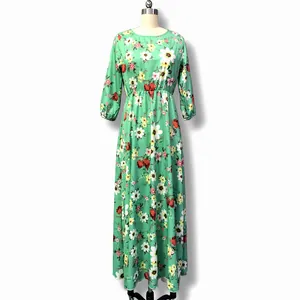 Long-sleeved green floral maxi dress for women on a mannequin, bohemian holiday style.