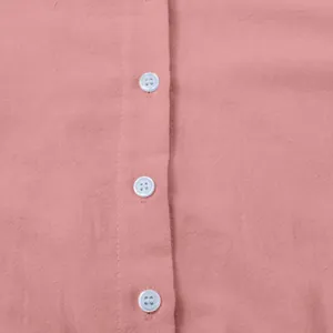 Detailed close-up of buttons and breathable linen fabric texture on a pink casual dress
