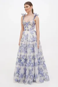 Detailed view of elegant blue floral organza tiered gown with tie bow shoulder straps