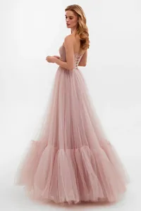 Detailed view of an elegant pink tulle ball gown featuring a sophisticated lace-up back design
