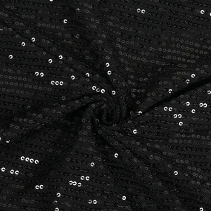Detailed view of shimmering black sequins on mesh fabric for sexy evening dress