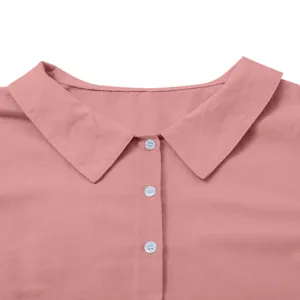 Detail shot of the lapel collar and buttons on a pink cotton linen casual dress