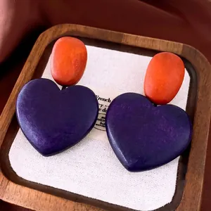 Elegant vintage wooden heart dangle earrings with purple and orange color-block design