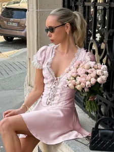 Elegant French style pink V-neck lace mini dress with puff sleeves and A-line silhouette.