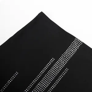 Detail view showing shiny silver rhinestone rows on black sexy slim fit dress fabric.