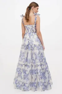 Back view of elegant long evening dress in blue floral organza with lace-up detail