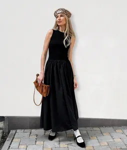 Vintage Hepburn style sleeveless black knit maxi dress with a cinched waist design.