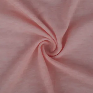 Detailed view of soft pink jersey fabric texture showing its knit pattern and drape