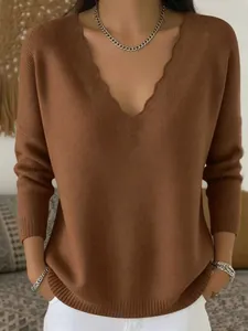 Detailed view of brown knit sweater featuring a unique scalloped V-neckline design