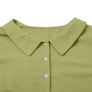 Close-up detail of the classic collar and white buttons on a moss green cotton linen dress