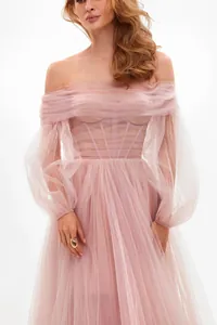 Elegant pink off-the-shoulder mesh formal dress detail with pearl and corset style.