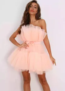 Elegant strapless pink tulle puff prom dress featuring a delicate satin bow belt.