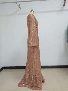 Side view of elegant rose gold sequined long sleeve floor-length evening gown