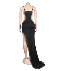 Detailed back view of a black rhinestone evening gown with mesh cut-outs and long train.