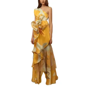 Elegant yellow one-shoulder maxi dress featuring a large 3D flower and vintage floral print