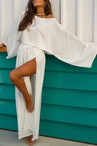 Bohemian white two-piece set featuring loose top and elegant high-slit maxi skirt